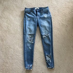 Distressed mid rise Vici jeans